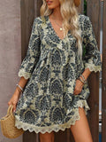 Front three-quarter view of navy ornamental V-neck mini dress with flounce sleeves and lace trim
