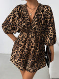 Front angled view of brown leopard V-neck romper with gathered waist and flowing sleeves