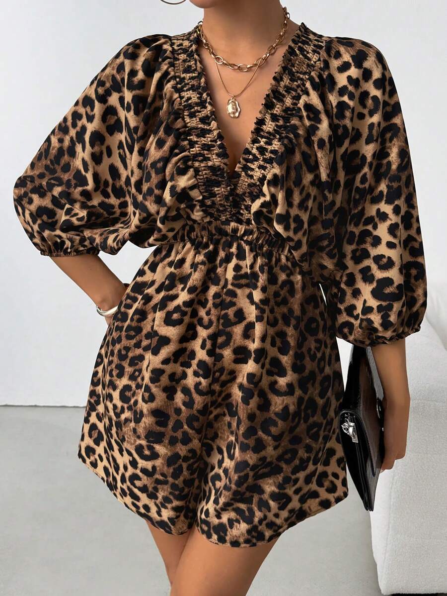 Front angled view of brown leopard V-neck romper with gathered waist and flowing sleeves