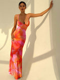Full front view of coral orange hibiscus floral maxi dress with spaghetti straps