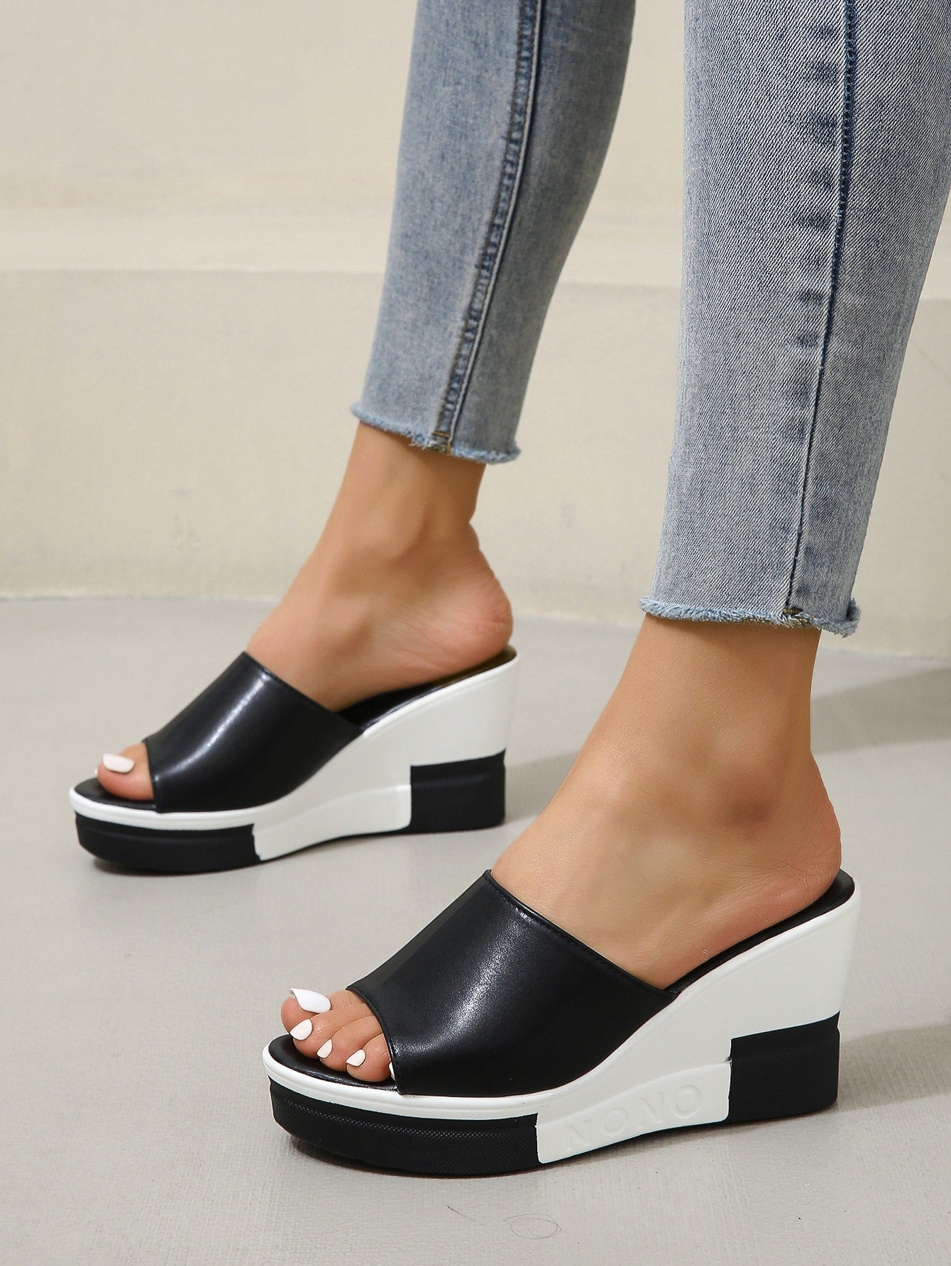 Indulge in ultimate summer style with Vacation Vibes: Black and White Sexy Peep Toe Slippers. The perfect addition to any beach or pool day, these peep toe slippers offer a comfortable and stylish way to show off your pedicure. With a sleek black and white design, these slippers are sure to elevate your summer look.