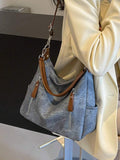 This roomy shoulder bag combines style and function with its trendy denim-like fabric and spacious interior. Perfect for carrying all your essentials and more, it features a detachable strap for versatile wear—switch from shoulder to crossbody in a snap. Whether you're out shopping or meeting friends, this playful bag adds a fun, casual vibe to any outfit.