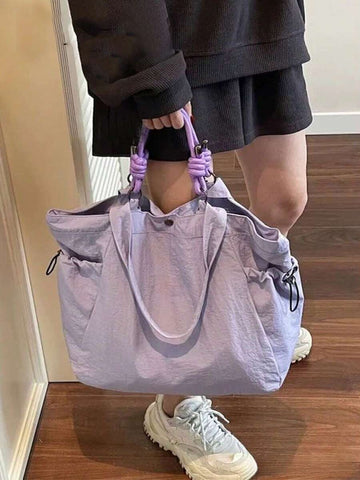 Tote it all with style! This lightweight nylon tote is your go-to companion for everything from textbooks to gym gear. With generous interior space and comfortable shoulder straps, it transitions seamlessly from campus to coffee runs to weekend adventures. The durable nylon construction keeps up with your busy lifestyle, while the sleek design works with any outfit. Whether you're heading to class, the gym, or just need a reliable everyday bag, this versatile tote has your back—literally!