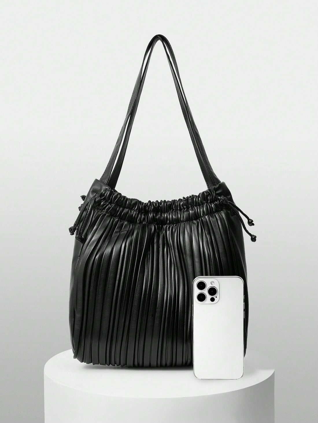 Add a splash of fun to your outfit with this versatile solid color pleated drawstring shoulder bag. Its playful pleats and easy drawstring closure keep your essentials secure while adding a chic twist to your look. Perfect for fashionistas who love style and convenience in one delightful package!