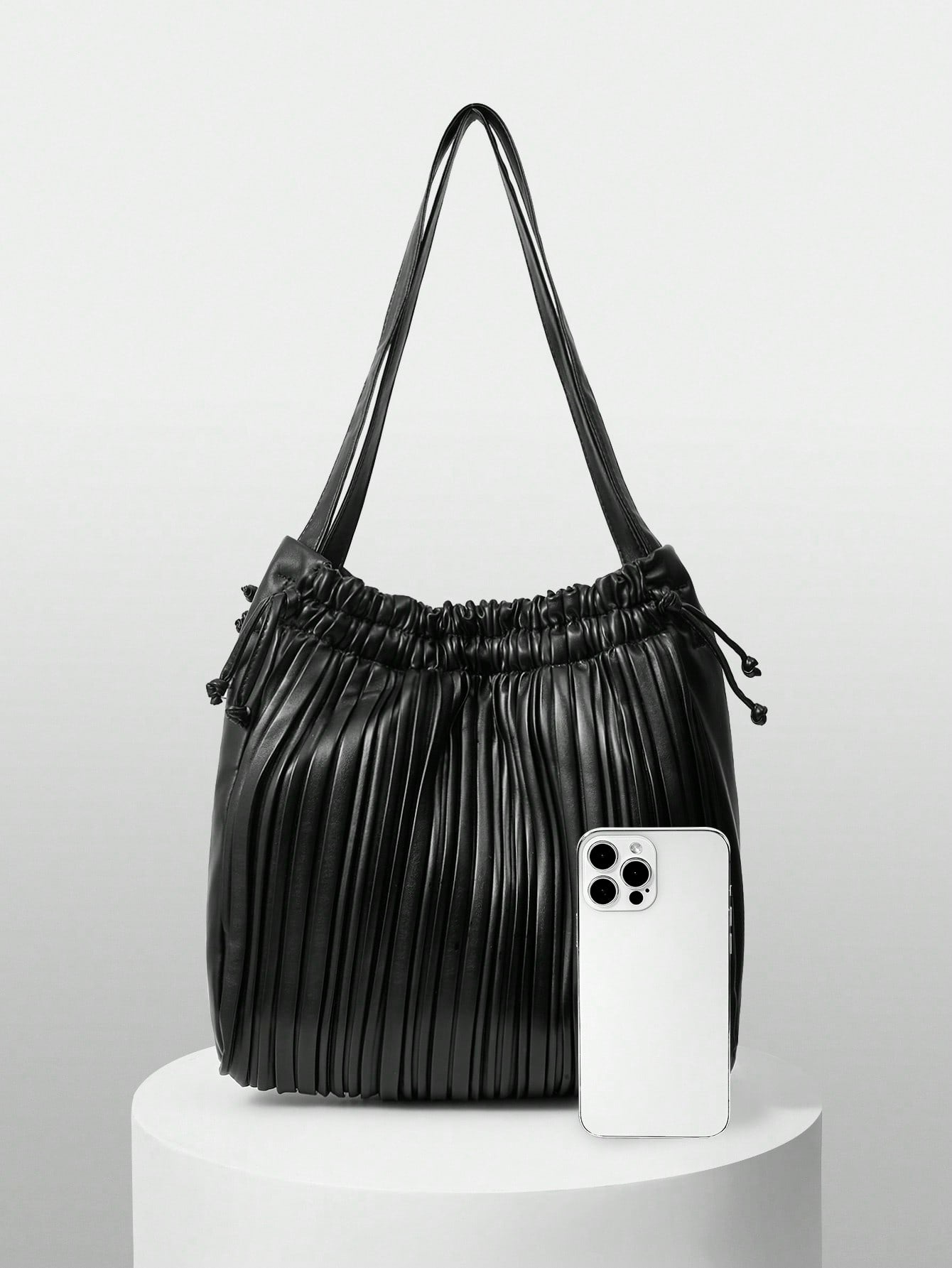 Add a splash of fun to your outfit with this versatile solid color pleated drawstring shoulder bag. Its playful pleats and easy drawstring closure keep your essentials secure while adding a chic twist to your look. Perfect for fashionistas who love style and convenience in one delightful package!