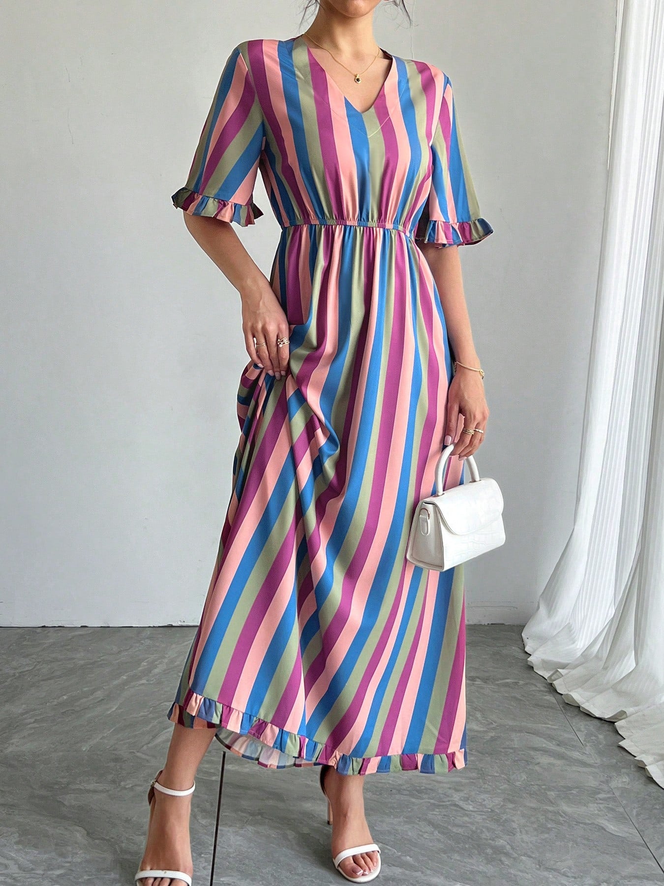 Unleash your playful side with our Vibrant Striped V-Neck Swing Dress with Ruffle Sleeves! Perfect for vacations and holidays, this dress will surely make a statement with its bright stripes and flirty ruffle sleeves. Say hello to your new go-to dress for any fun occasion!