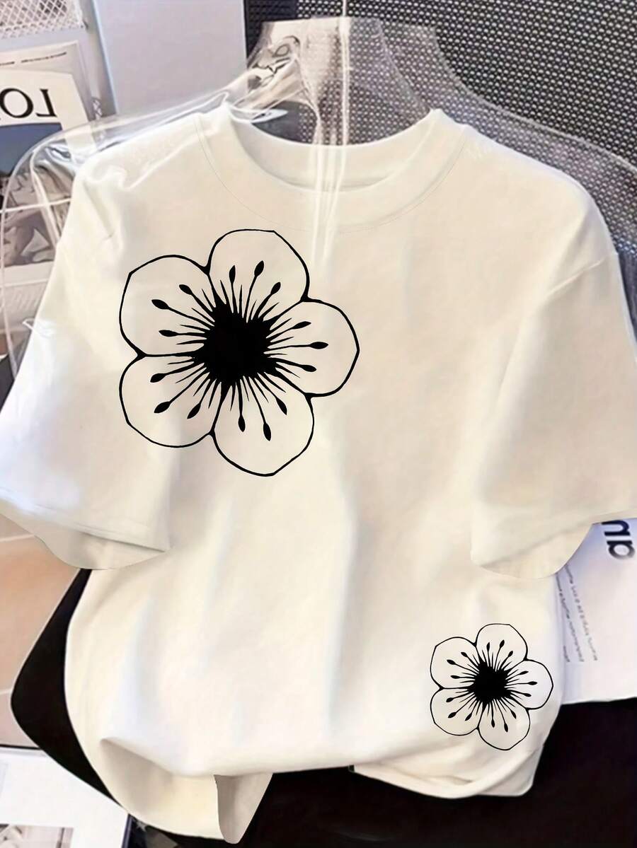 Step back in time with this charming vintage-inspired tee featuring a striking black and white floral print. The relaxed fit drapes beautifully for all-day comfort, while short sleeves keep you breezy during warmer months. Perfect for spring and summer adventures, this timeless piece pairs seamlessly with denim, linen pants, or casual skirts. The classic botanical design brings understated elegance to your everyday rotation. A wardrobe staple that never goes out of style.
