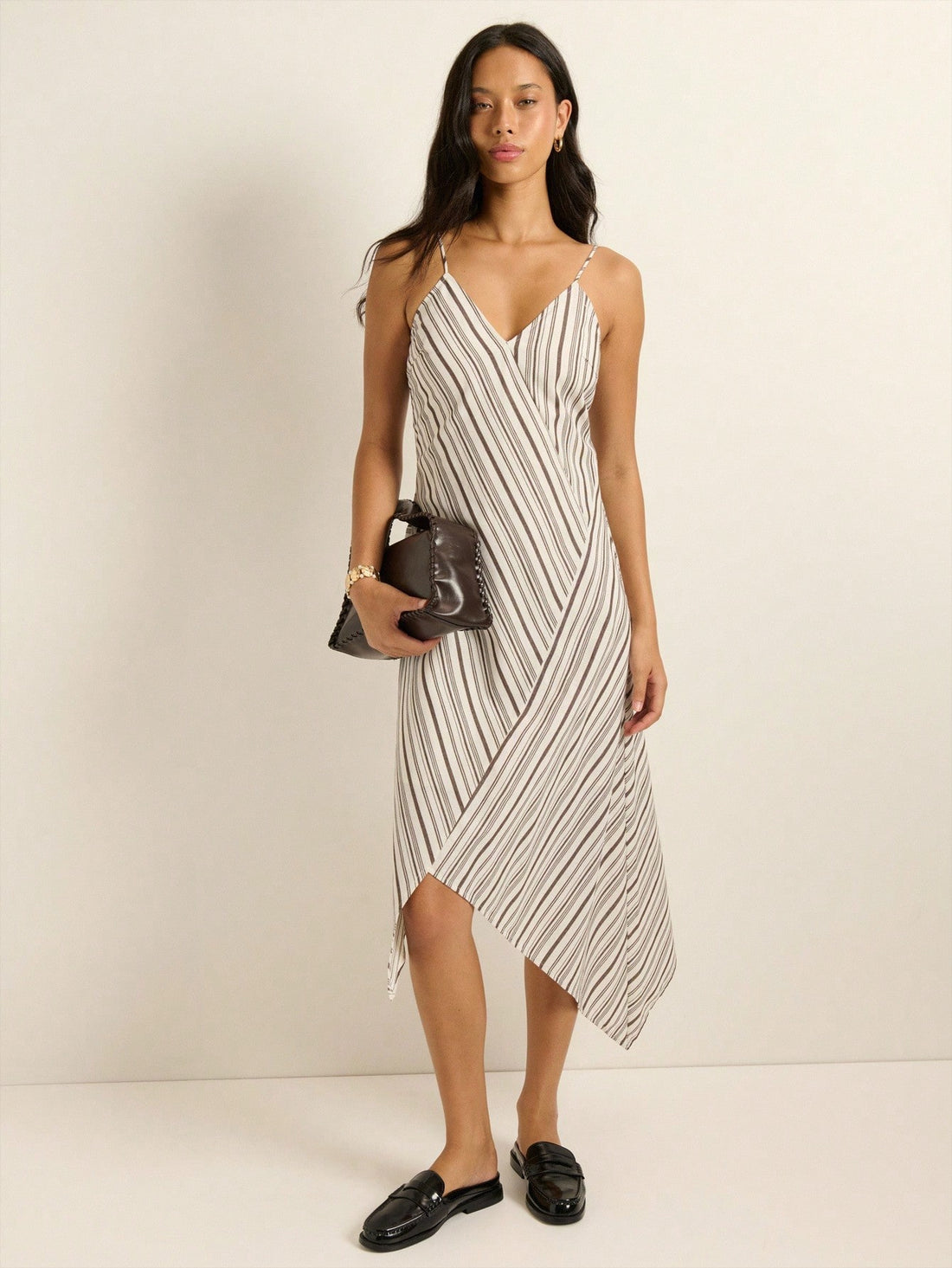 Make a statement with this vintage-inspired dress that effortlessly blends retro charm with modern edge. The crisp white base pairs beautifully with bold black stripes, while the daring deep V-neckline adds instant sophistication. The asymmetrical hem keeps things playful and unexpected, giving you that coveted streetwear vibe. Layer it over a tee or style solo—this versatile piece transitions seamlessly from fall into winter, proving that timeless style never goes out of fashion.