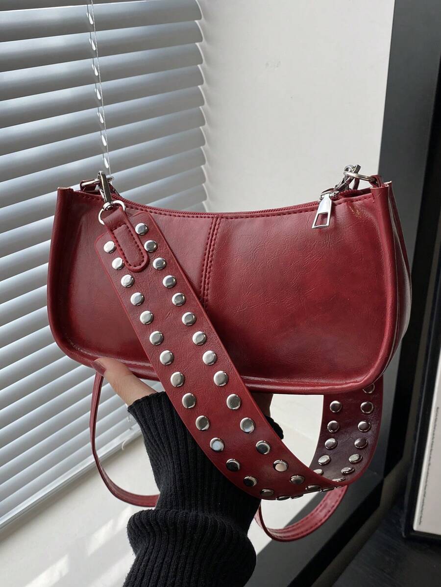 Add a dash of retro charm to your outfit with this vintage-inspired rectangular handbag. Featuring eye-catching rivet accents and a smooth zipper closure, it’s the perfect playful companion for your daily adventures. Comfortable to wear on the shoulder and spacious enough for your essentials, this chic bag brings both style and function to your look.