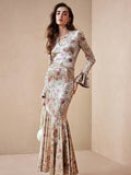 Embrace timeless elegance with this vintage-inspired French ditsy floral dress, perfect for autumn and winter celebrations. Featuring a flattering keyhole neckline, flare sleeves, and a high-waisted silhouette, this slim-fit design showcases a romantic mermaid hem with delicate ruffle detailing. The multicolor botanical print adds sophisticated charm to any formal occasion. Crafted from a comfortable knitted fabric blend of 95% polyester and 5% elastane with medium stretch, this dress moves with you while m