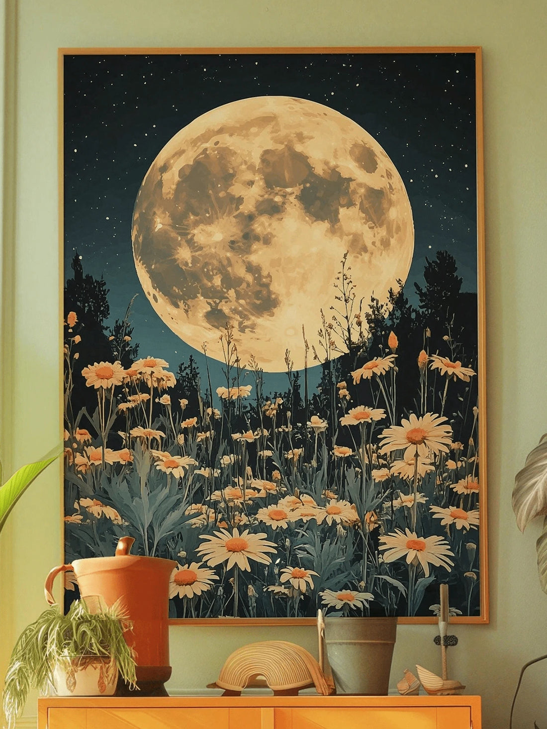 Moonlit daisy meadow wall art in a warm wood frame above a cabinet