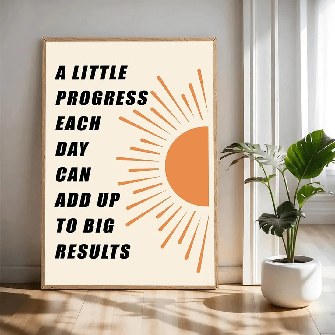 Quote canvas print with orange half sun in a sunlit room