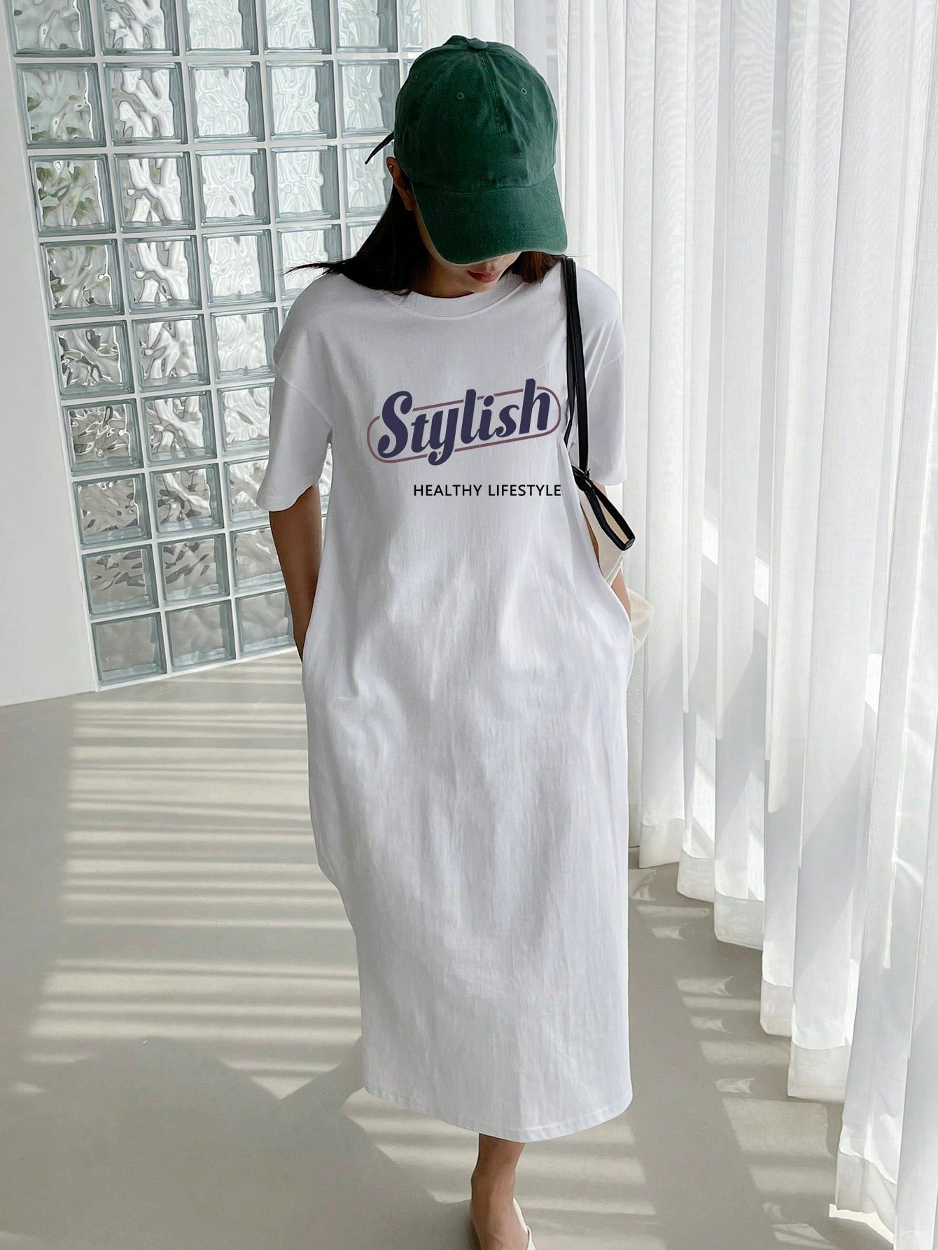 Rock effortless style and comfort with our Vintage Slogan Graphic Drop Shoulder Tee Dress. Made from premium materials, this dress features a trendy vintage slogan graphic and drop shoulder design for a relaxed and stylish look. Perfect for casual days and adding a playful touch to your wardrobe.