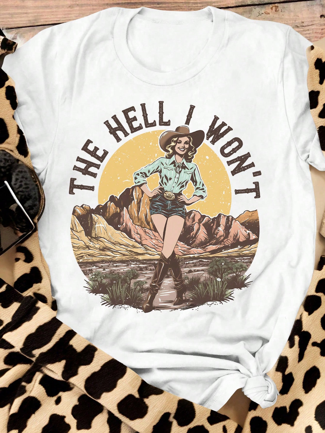 Embrace the wild west in style with our Vintage Western Landscape Graphic Tee! This playful, plus size t-shirt features a vintage western landscape graphic and a comfortable, casual short sleeve design. Perfect for any modern cowgirl. Giddy up!