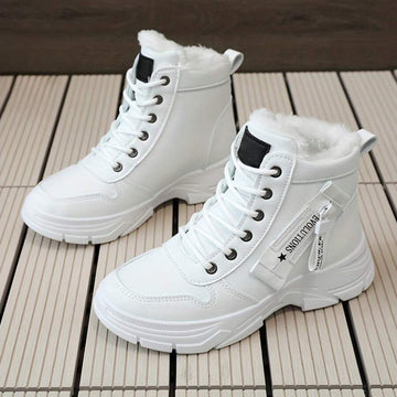 Front three-quarter pair view of white faux-fur lace-up ankle boots with star straps