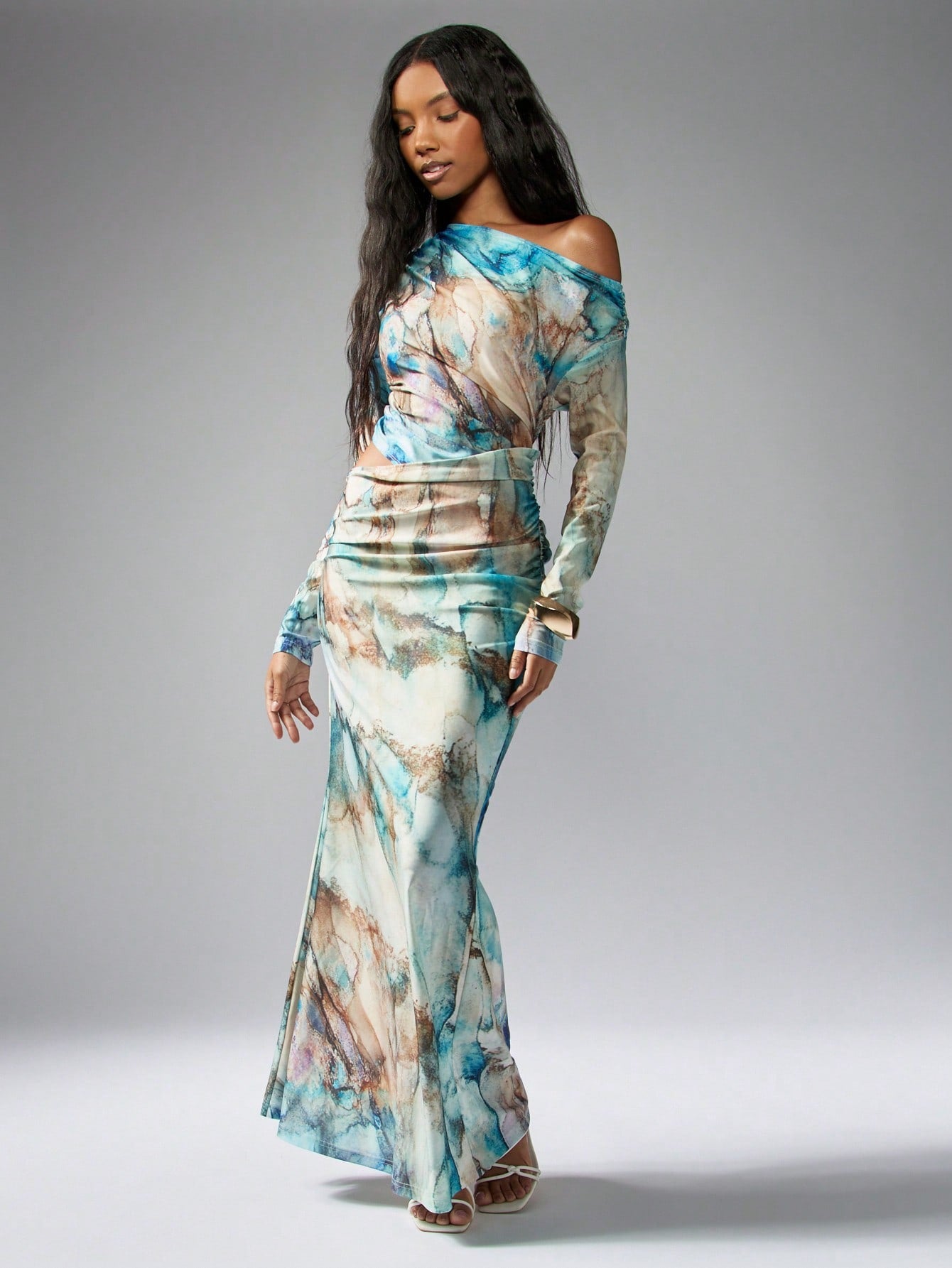 Get ready to make a statement in our Watercolor Illusion Maxi Dress! With its stunning watercolor print, figure-flattering waist detail, and elegant maxi length, this dress is perfect for any occasion. Plus, the long sleeves add a touch of sophistication while keeping you warm on cooler evenings. Bring your outfit to life with this eye-catching dress!