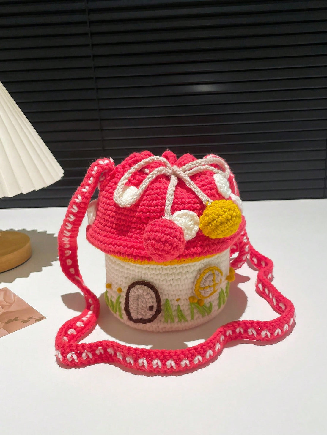 Enhance your style with our Whimsical Color Block Mushroom House Knitted Crossbody Bag. Made of high-quality materials, this bag is both stylish and functional. Its unique design adds a touch of whimsy to any outfit, while its crossbody style ensures comfort and convenience. Perfect for any adventure, this bag is a must-have for the fashion-forward individual.