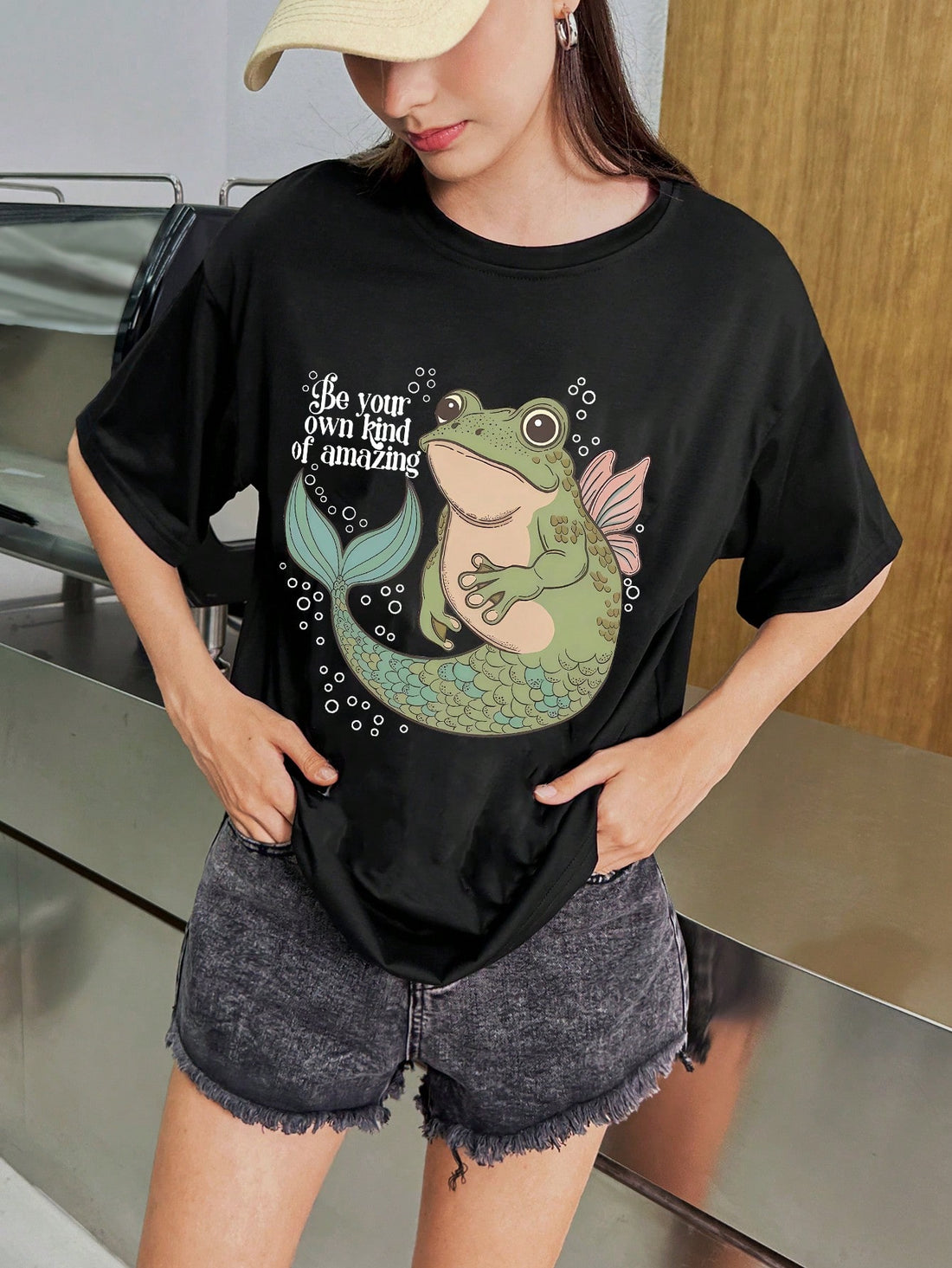 This playful and unique t-shirt features a whimsical design of a frog mermaid, perfect for women who love to add a touch of fun to their wardrobe. Made with high-quality materials, this shirt is both comfortable and stylish. Show off your love for whimsy with this one-of-a-kind graphic t-shirt.