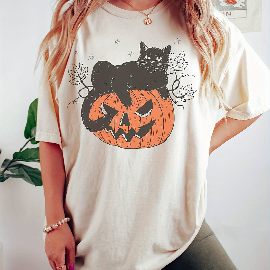 Effortlessly add a touch of whimsy to your wardrobe with our Whimsical Pumpkin Cat Print T-Shirt. This must-have for any women's clothing collection features a charming pumpkin cat design that is sure to delight. With its comfortable fit and eye-catching print, it's the perfect addition to any outfit.