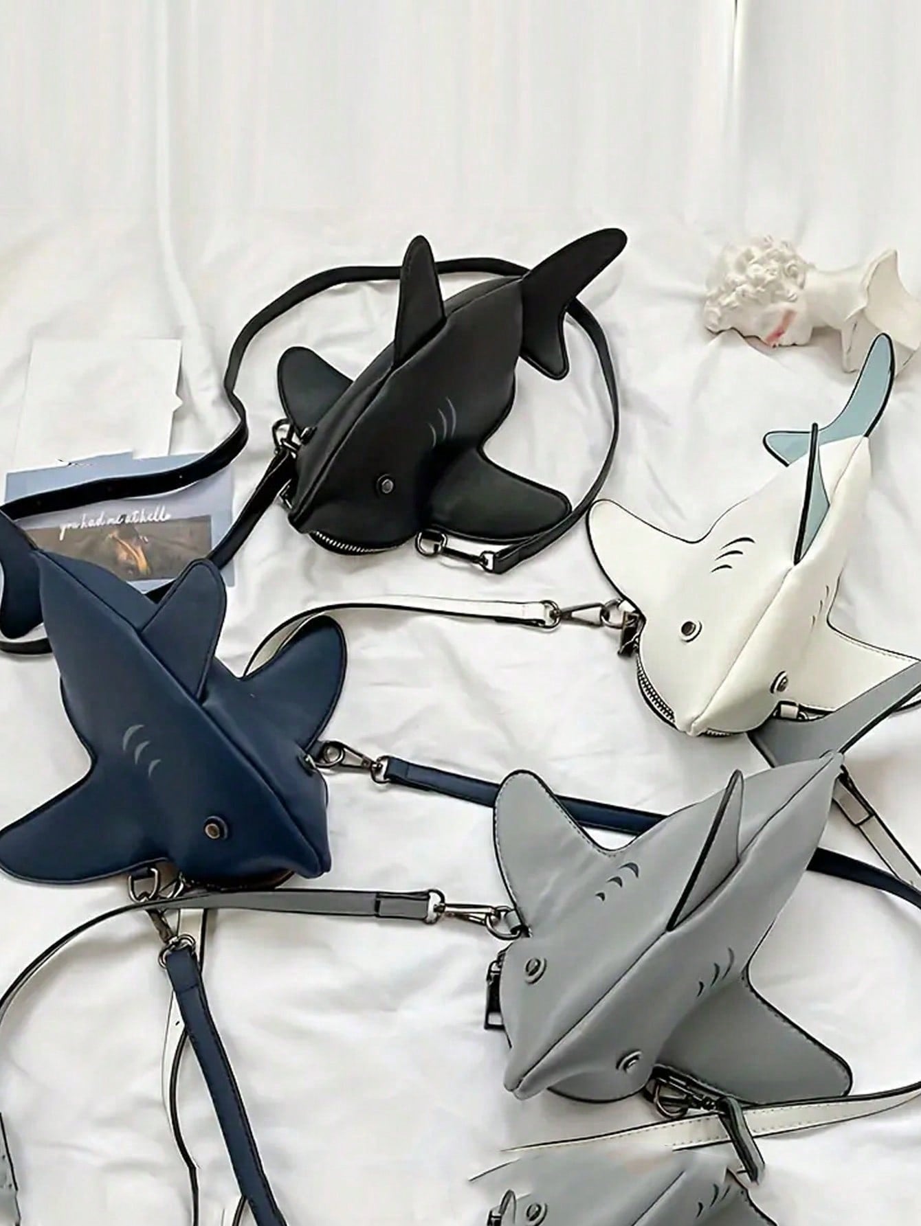 Add some bite to your style with this Whimsical Shark Crossbody Bag! This playful and trendy bag features a cute stuffed animal design that will surely make a splash. Perfect for any fashion-forward woman, this quirky bag is a must-have accessory. Get ready for jaws to drop wherever you go!