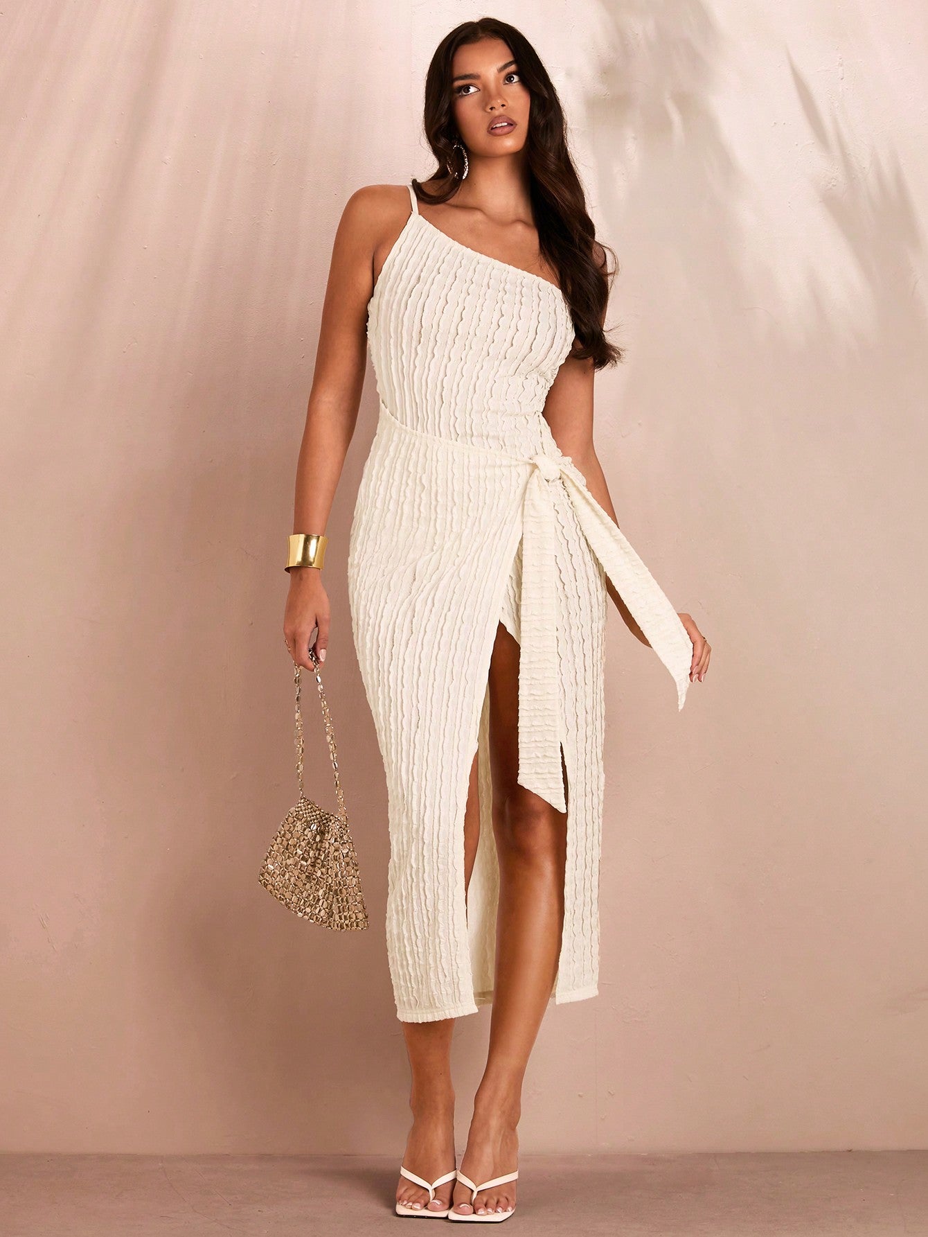 Introducing our White Asymmetric Textured Bodycon Dress, the perfect choice for effortless summer style. The high slit adds a touch of sultry to the textured design, while the bodycon fit flatters your figure. Stay cool and chic this season with this must-have dress.