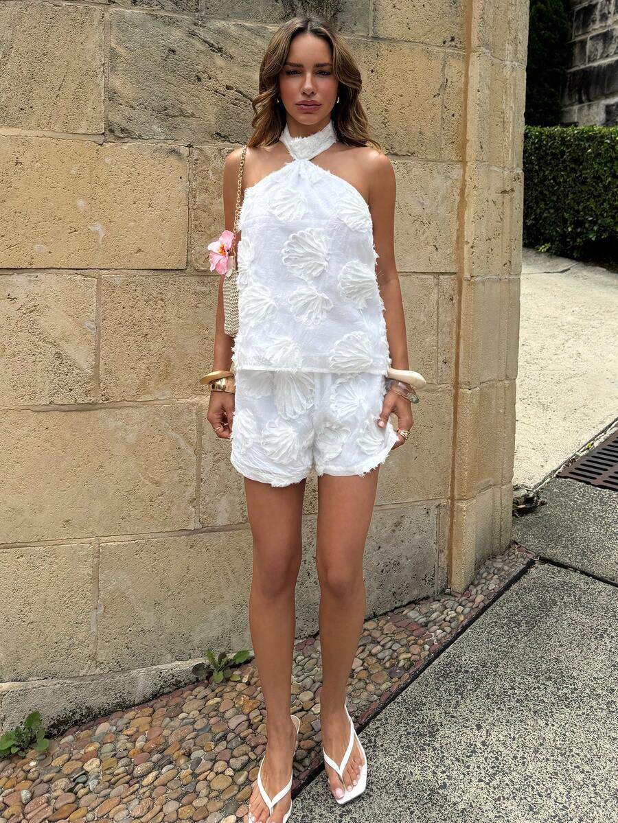 Elevate your special moments in this stunning white halter neck embroidered 2-piece set. The delicate embroidery adds timeless elegance, while the flattering halter design creates a sophisticated silhouette perfect for weddings, romantic dinners, and sun-soaked getaways. 
