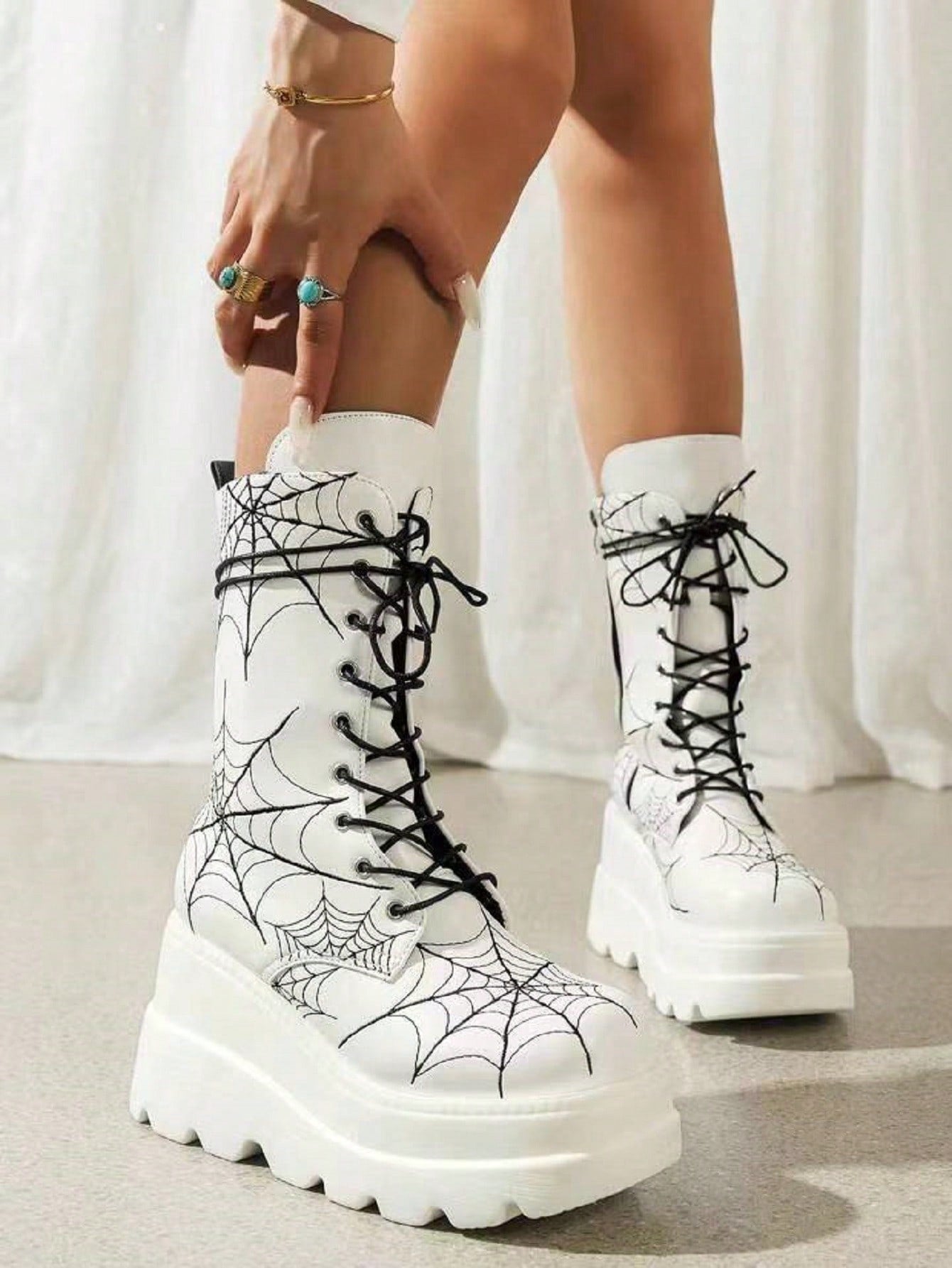 These White Spider Embroidered Thick-Soled Boots are the perfect combination of fashion and function. With a stylish high heel design and mid-calf length, these boots will elevate any outfit. The thick-soled construction provides superior comfort and stability, making these boots ideal for all-day wear. Step out with confidence and style in these must-have boots for women.