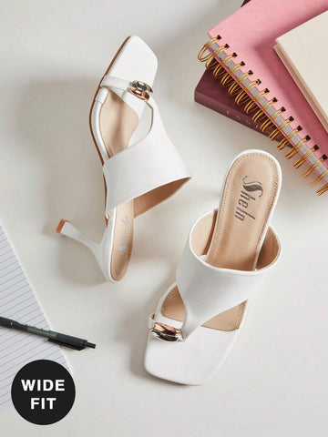 Enjoy the perfect blend of style and comfort with these Wide Fit Toe Ring Heeled Sandals for Women. Designed with a spacious wide-fit construction, a modern toe ring, and a sleek thick band upper, these sandals provide a secure yet comfortable fit while adding a sophisticated touch to any outfit.