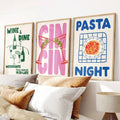 Three framed food and drink canvas prints above a bed: Wine & Dine, Gin Gin, and Pasta Night