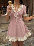 Dusty pink ruffle tie-front skater mini dress in front café detail view