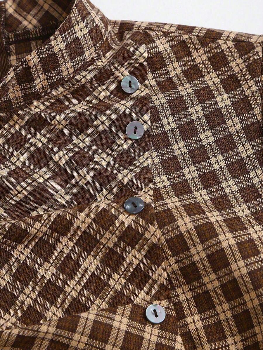 Close-up of brown plaid mini dress stand collar, diagonal button placket, and woven texture