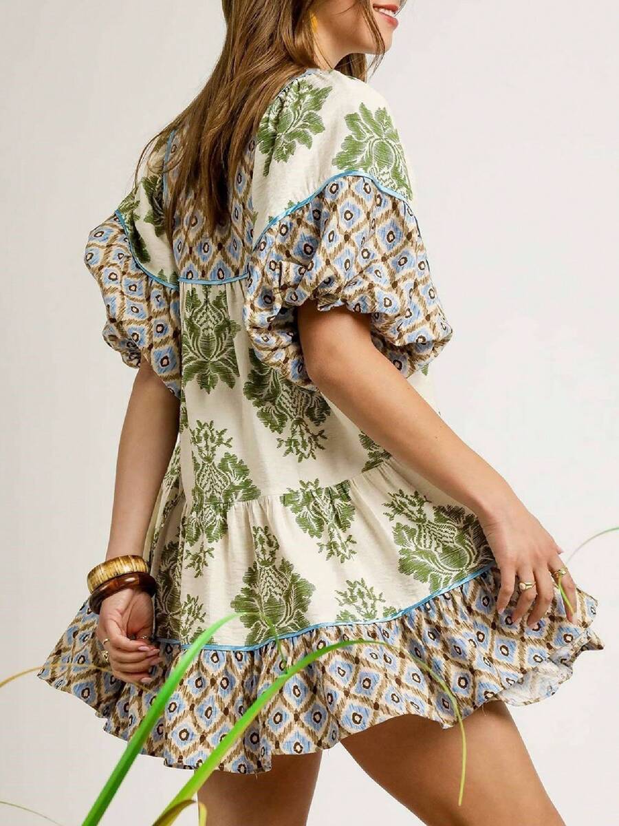 Rear three-quarter view of olive patchwork swing mini dress with contrast yoke and ruffle hem