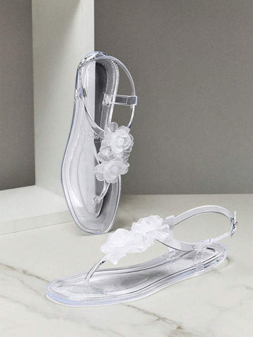 Step into effortless summer style with these clear jelly flat sandals, designed for all-day comfort and casual wear. The transparent upper showcases delicate floral decor details, creating a fresh, feminine look that pairs perfectly with any warm-weather outfit. Crafted from soft, flexible jelly material, these sandals mold to your feet for a custom fit. The flat sole provides reliable support for everyday activities, while the lightweight construction keeps your feet cool and comfortable throughout the day