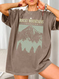 Casually conquer mountains in this quirky tee! Featuring a relaxed fit and trendy graphic print, this t-shirt is the perfect addition to your wardrobe. With its soft fabric and short sleeves, you'll stay comfortable and stylish all day. Reach new heights in this playful mountain-inspired top.