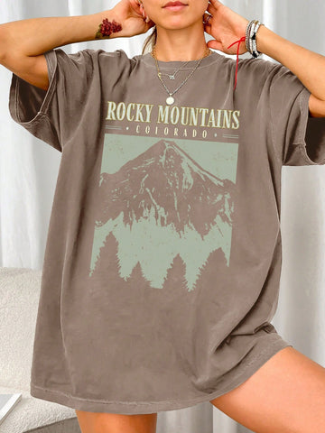 Casually conquer mountains in this quirky tee! Featuring a relaxed fit and trendy graphic print, this t-shirt is the perfect addition to your wardrobe. With its soft fabric and short sleeves, you'll stay comfortable and stylish all day. Reach new heights in this playful mountain-inspired top.