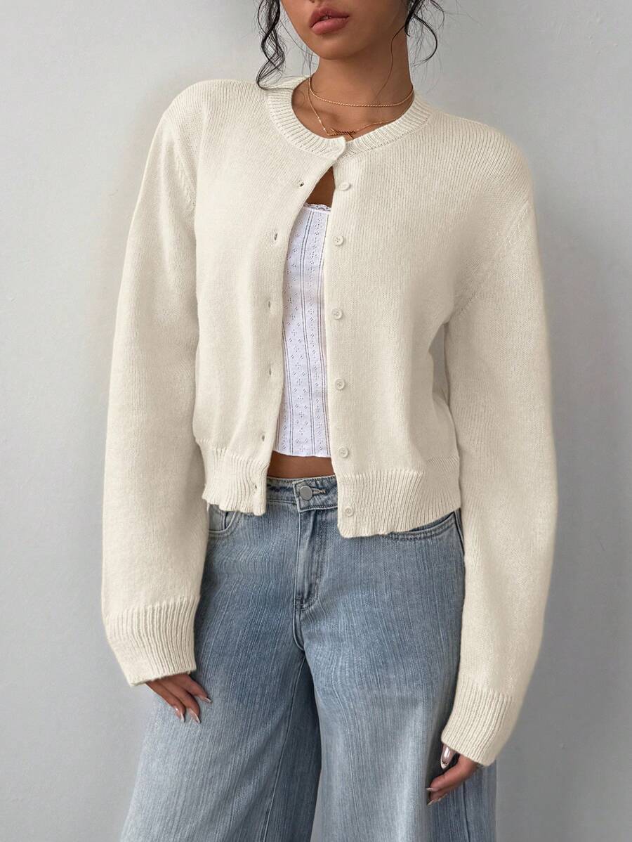 Refresh your everyday wardrobe with this Women's Cropped Knit Sweater, designed with a classic round neckline and long sleeves for a timeless, easy-to-style look. The cropped silhouette adds a modern touch while the soft knit fabric provides lightweight warmth and all-day comfort. Perfect for layering or wearing on its own, this versatile pullover pairs effortlessly with high-waisted jeans, skirts, leggings, or trousers for casual outings, work, school, or weekend adventures.