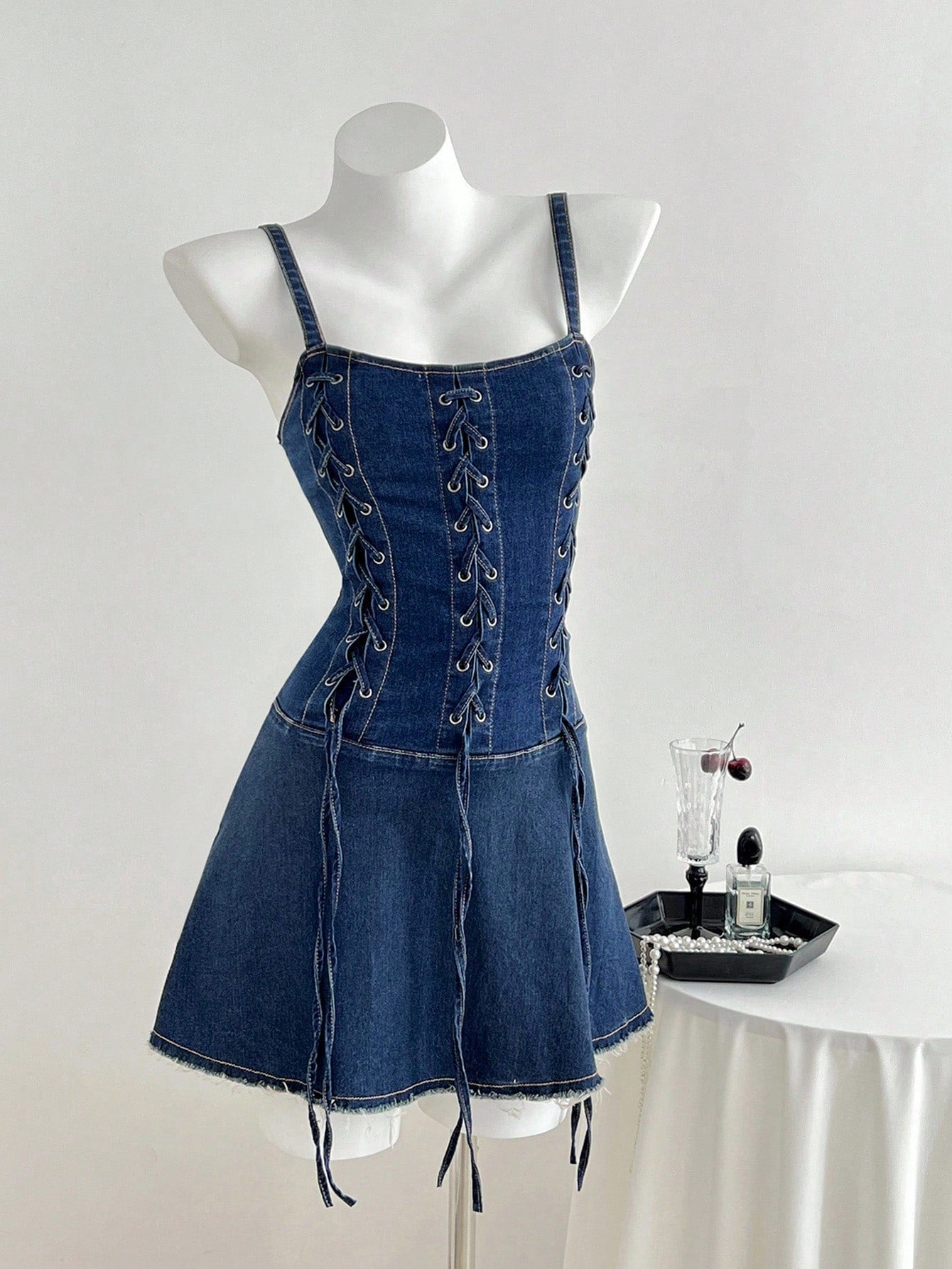 Elevate your wardrobe with this show-stopping denim corset camisole dress that blends edgy sophistication with effortless style. The structured corset bodice features a flattering lace-up front that lets you customize your fit while making a bold fashion statement. Perfect for date nights, nights out, or whenever you want to turn heads, this versatile piece pairs beautifully with sneakers for casual vibes or heels for dressed-up moments. The classic denim construction ensures durability, while the camisole 