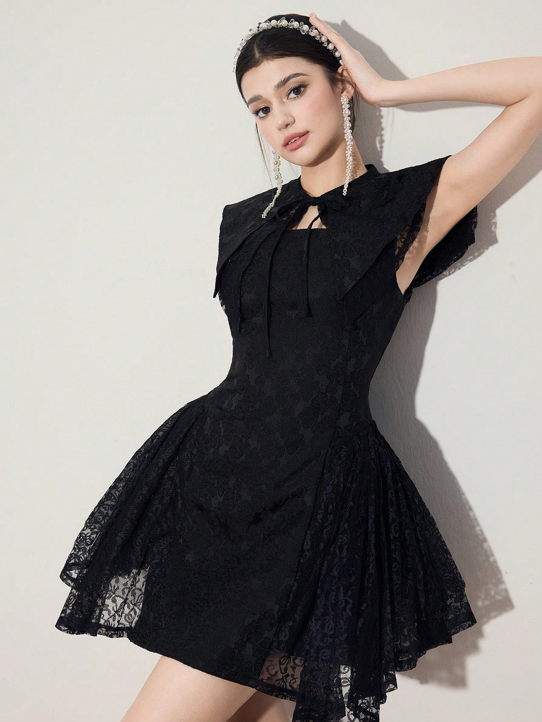 Step out in style with this playful yet elegant jacquard dress featuring a charming tie-neck and flirty ruffle hem. Perfectly short for twirling, it blends timeless sophistication with a fun, feminine twist. Whether for brunch or a night out, this dress adds a delightful pop to your wardrobe.