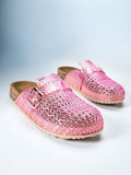 Translucent pink woven jelly clog mules with buckles, cork-look footbeds, and beige soles