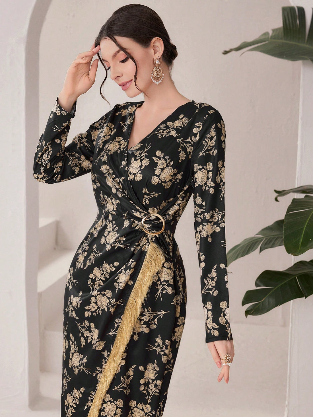 Slip into this gorgeous floral printed evening dress, complete with a fringed hem for added flair. Perfect for any special occasion, you'll feel both elegant and playful in this unique and stylish dress. Why blend in when you can stand out in this must-have piece!
