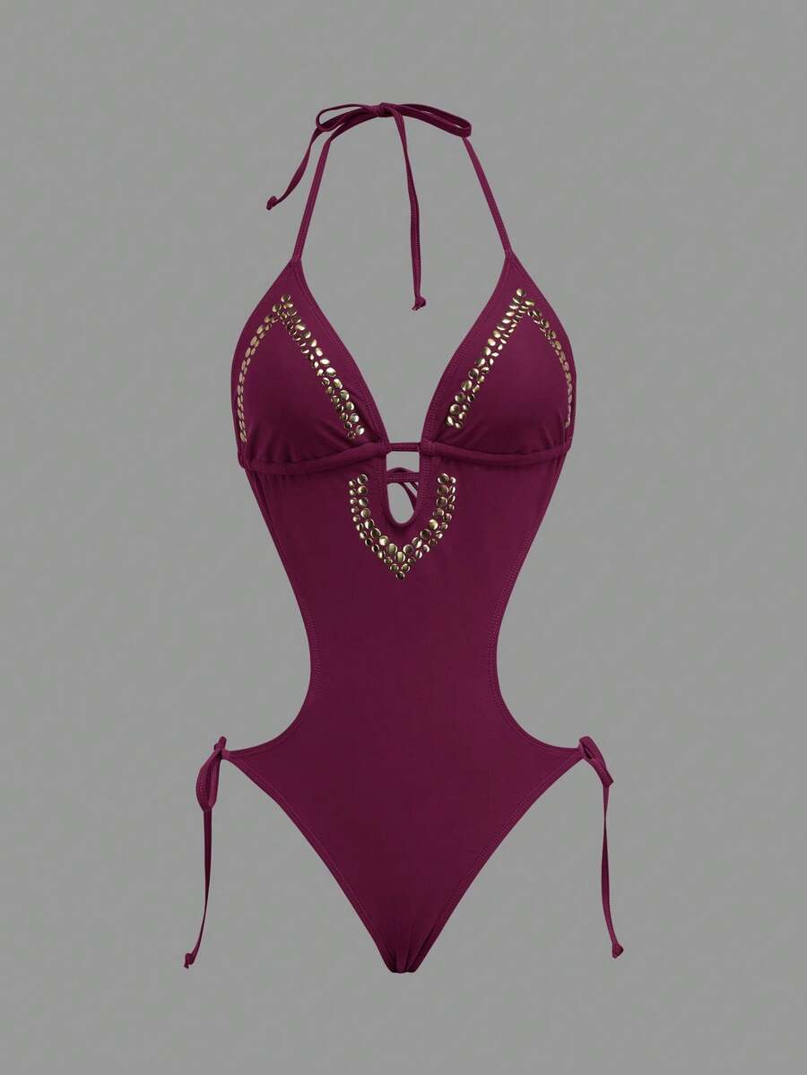 Front worn view of burgundy halter studded cutout one-piece swimsuit with deep V neckline and hip ties for beach party styling