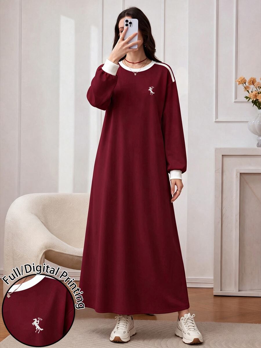 Front view of a model in a burgundy sweatshirt maxi dress with white crew neck, shoulder stripe and small chest embroidery
