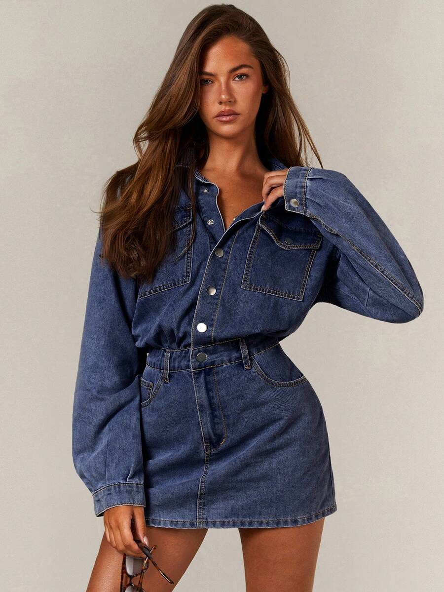 Front close view of washed blue denim shirt and mini skirt set with snap front and utility pockets