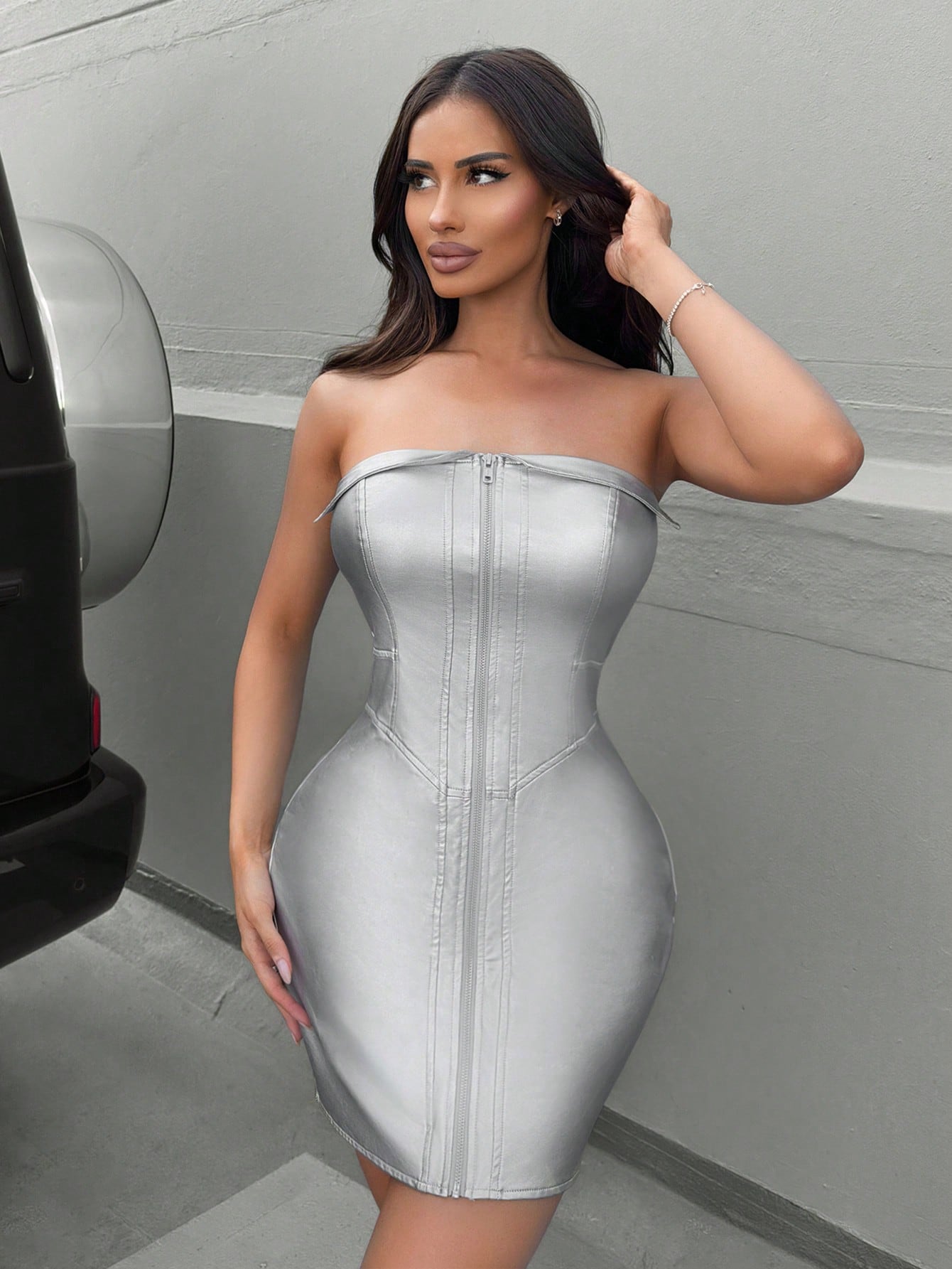 Unleash your bold and daring style with our Women's Metallic Strapless Front Zipper Dress. The chic design features a striking front zipper, adding a touch of elegance to the sleek metallic finish. Perfect for a confident and sophisticated look.