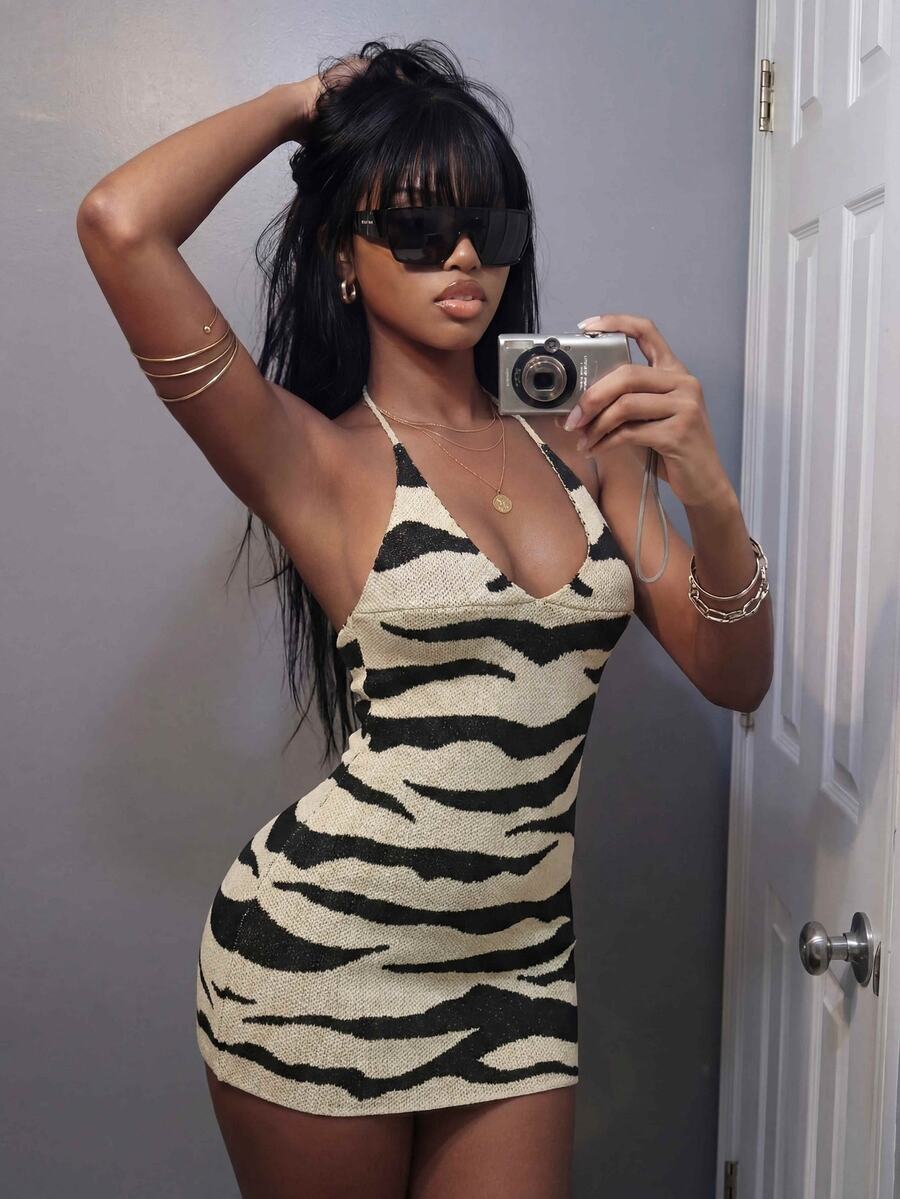 Front mirror view of cream and black zebra knit halter mini dress with V-neck and bodycon fit