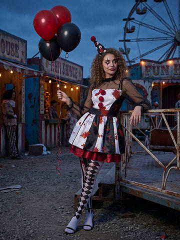 Full view of scary red black and white clown costume in abandoned carnival setting