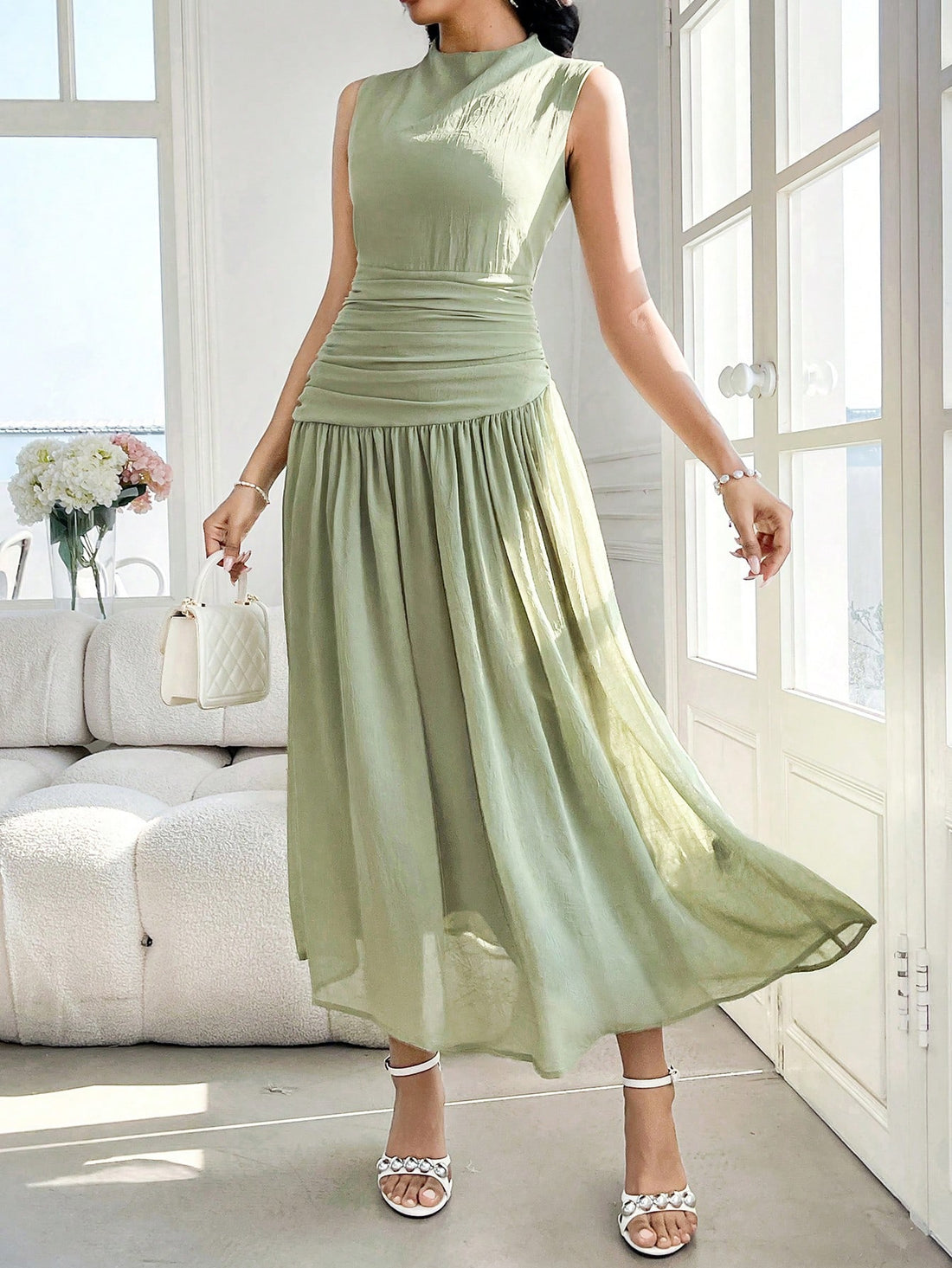 Introducing our Women's Sleeveless High Neck Ruched Midi Dress, a perfect blend of elegance and chic style for any occasion. With its high neck and ruched detailing, this dress will make you stand out in a crowd. Perfect for any event, from weddings to parties, this dress is a must-have for any fashion-forward woman.