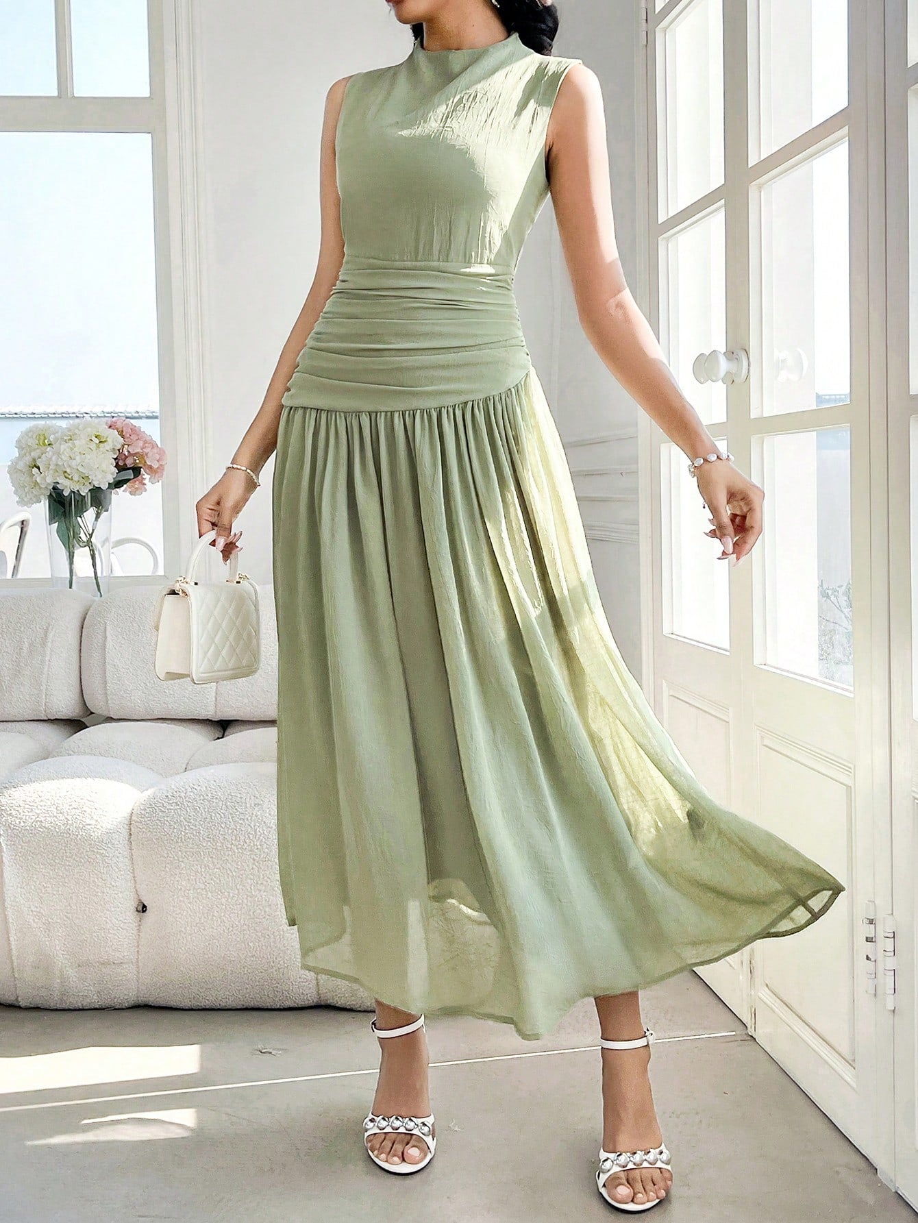 Introducing our Women's Sleeveless High Neck Ruched Midi Dress, a perfect blend of elegance and chic style for any occasion. With its high neck and ruched detailing, this dress will make you stand out in a crowd. Perfect for any event, from weddings to parties, this dress is a must-have for any fashion-forward woman.