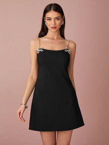 Step into the season with our Women's Spring/Summer Black Mini Suspender Dress! Featuring a cute rhinestone bow and subtle sparkle, this dress will have you turning heads. Plus, the suspenders add a playful twist to this must-have dress. Perfect for any occasion, you'll feel confident and stylish all day long!