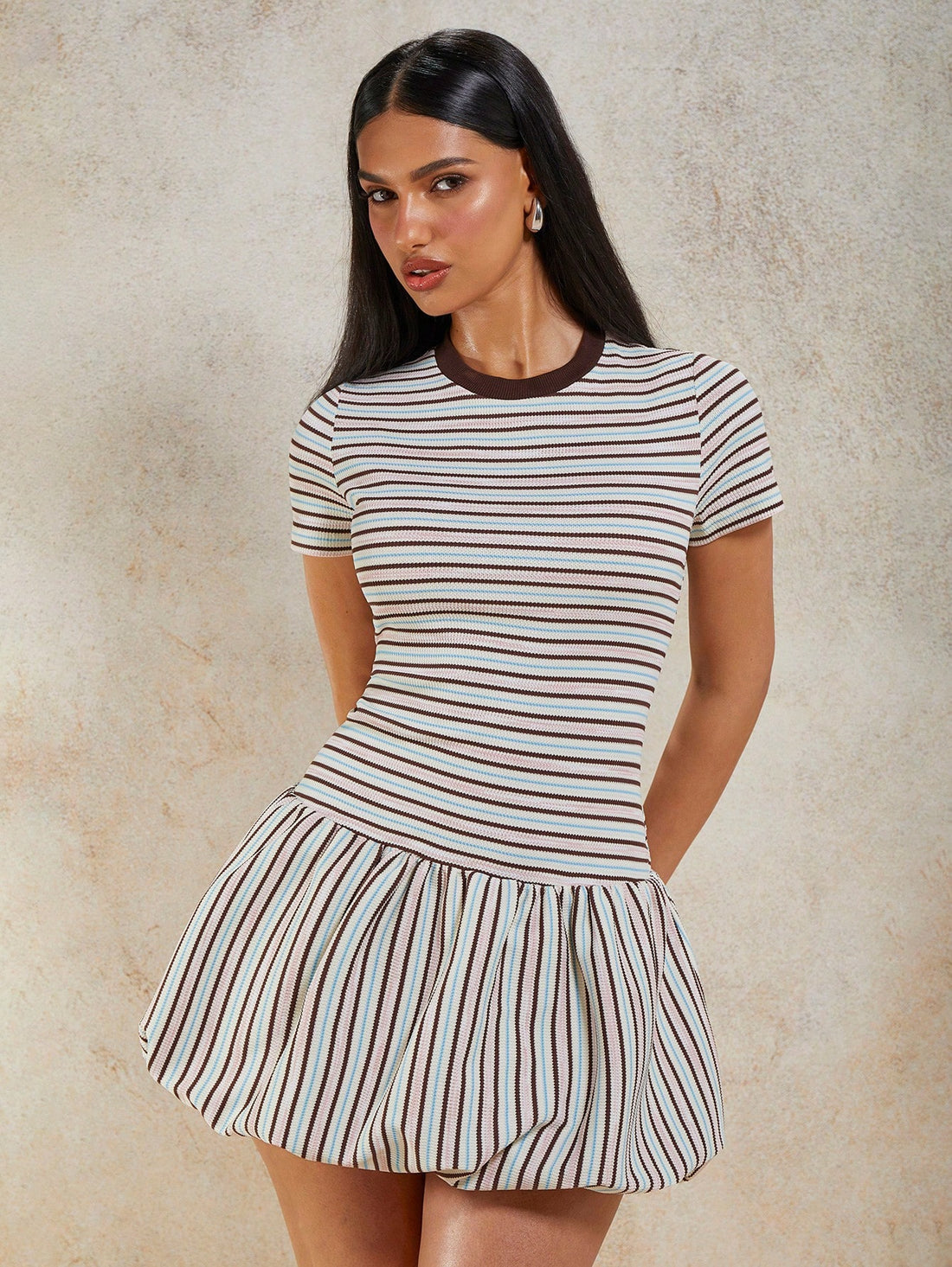 Turn heads in this charming striped mini dress that effortlessly blends retro vibes with modern flair. The playful ruffle hem adds a flirty touch, while the drop waist creates a flattering silhouette that's perfect for any occasion. Short sleeves and a classic round neckline keep things comfortable and versatile, making it ideal for casual outings, weekend brunches, or spontaneous adventures. Whether you're dressing it up with heels or keeping it cool with sneakers, this striped beauty is your go-to piece f